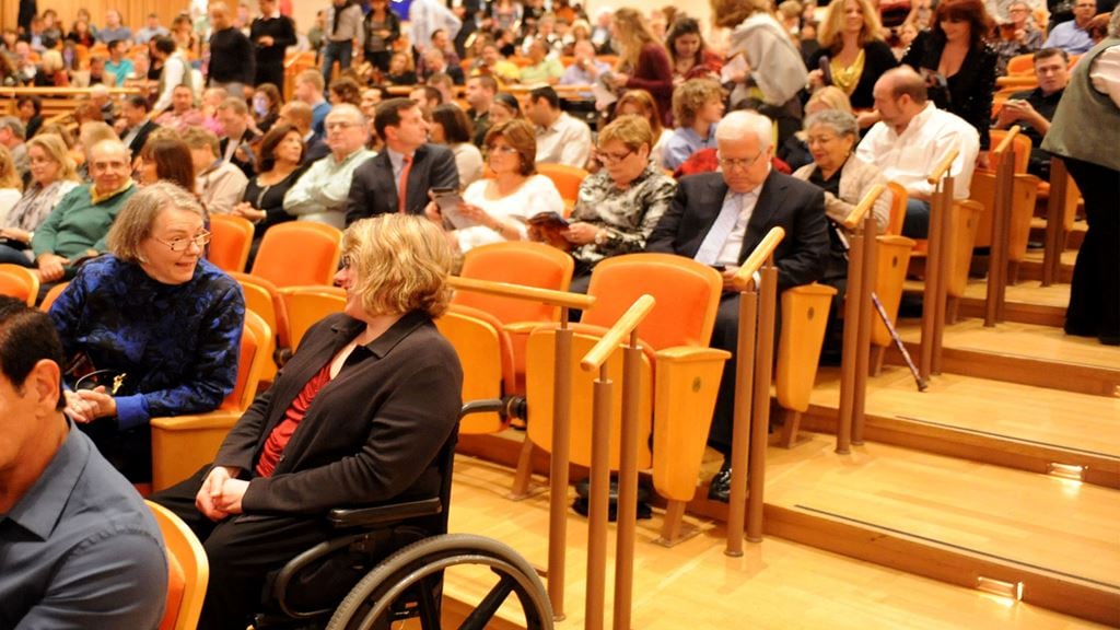 Crowd shot in opera house and wheel chair seat