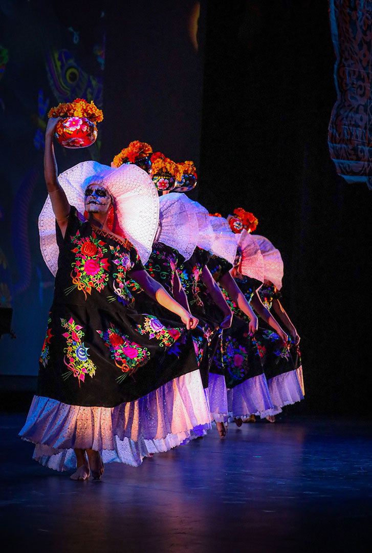 Calpulli Mexican Dance Company dancers in Día de Muertos costume